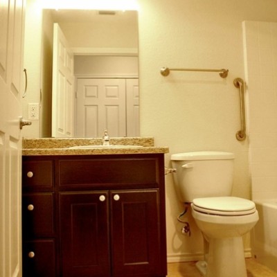 Bathroom with small mirror, a sink and toilet