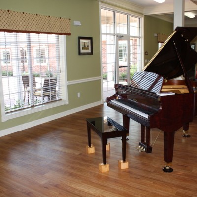 Large room with window and piano