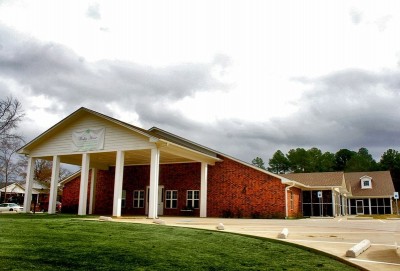 Building entrance with large columns and drive thru