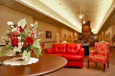 Long common area with red couch and chairs