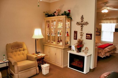 Cozy living room with recliner, display cabinets and fake fireplace