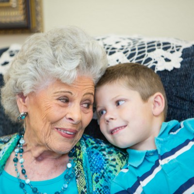 white haired smiling woman with young boy